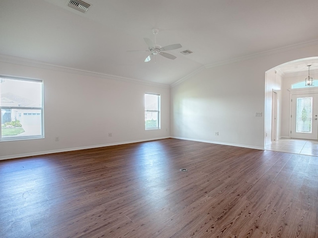 empty room featuring crown molding, lofted ceiling, dark hardwood / wood-style flooring, and ceiling fan