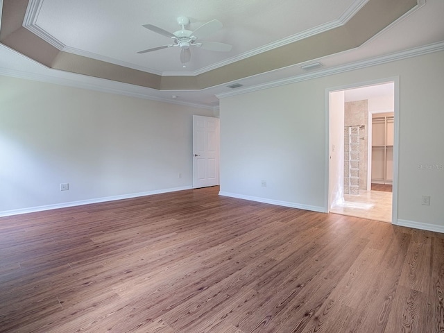 unfurnished room featuring crown molding and a raised ceiling