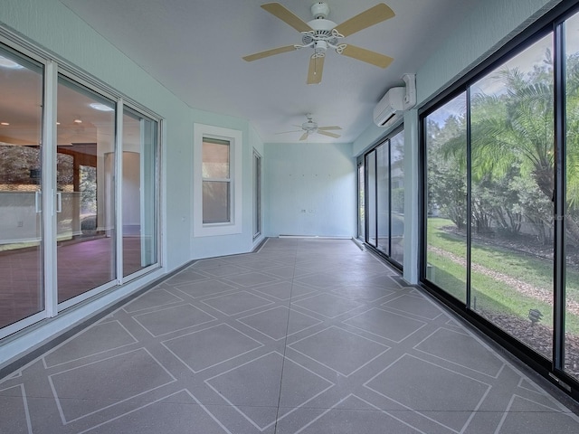 unfurnished sunroom featuring an AC wall unit and ceiling fan