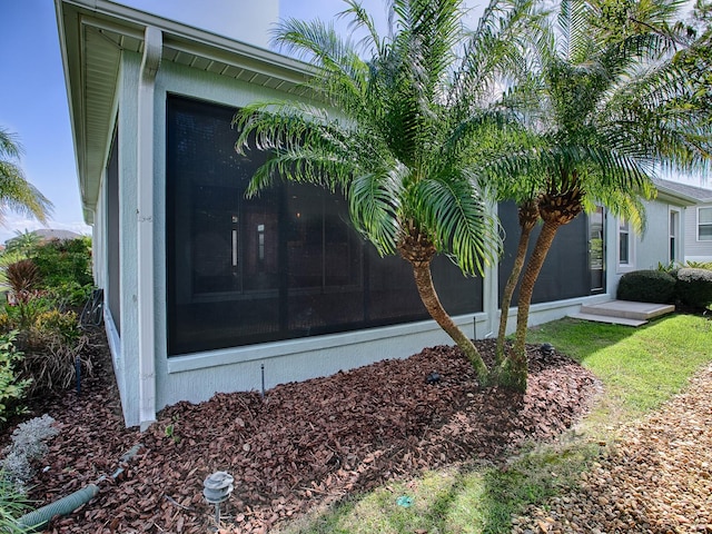 view of home's exterior with a sunroom