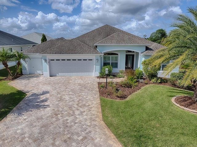 ranch-style house with a front lawn and a garage