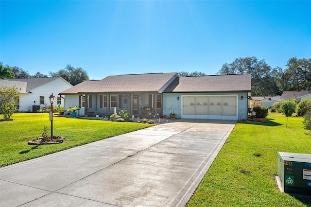 ranch-style home featuring a front lawn, central AC unit, and a garage