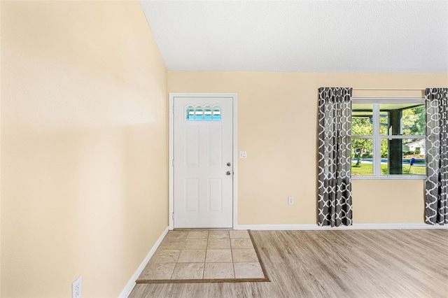 entryway featuring light hardwood / wood-style floors and a textured ceiling