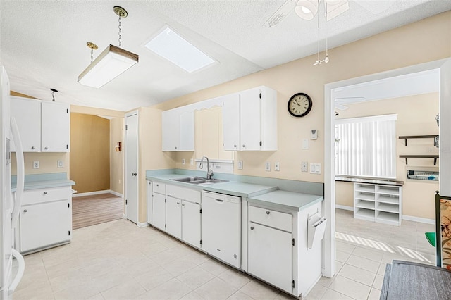 kitchen with dishwasher, hanging light fixtures, sink, white cabinets, and ceiling fan