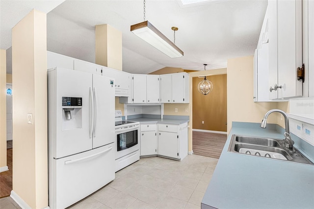 kitchen with white appliances, lofted ceiling, pendant lighting, and white cabinets