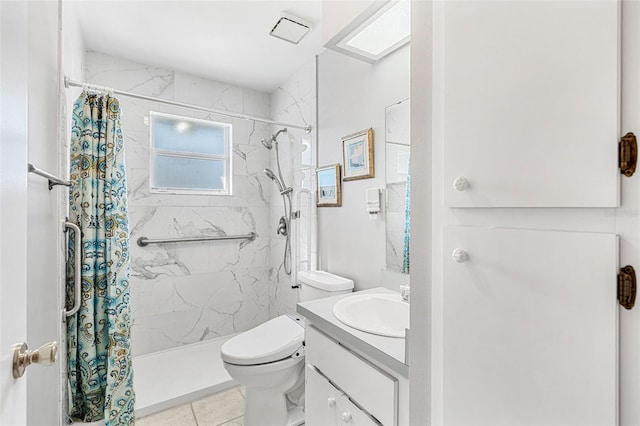 bathroom with toilet, a skylight, vanity, tile patterned floors, and a shower with shower curtain