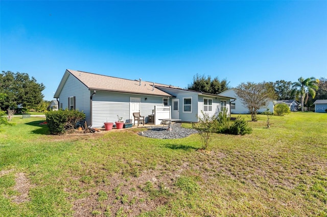 rear view of house with a yard