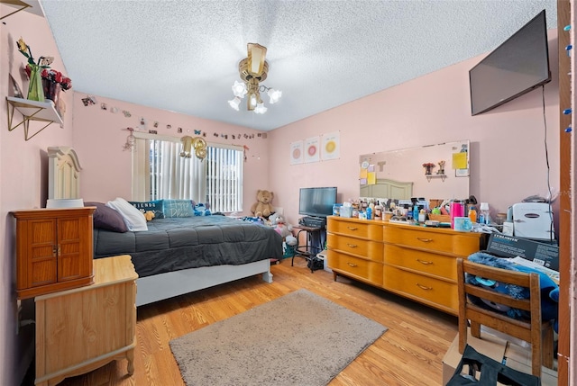 bedroom featuring a textured ceiling and light wood-type flooring