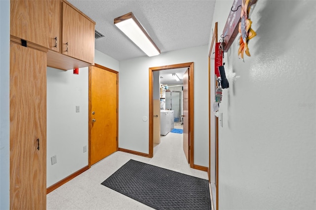 hall with a textured ceiling