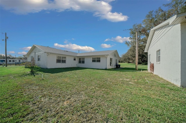 back of property with a lawn