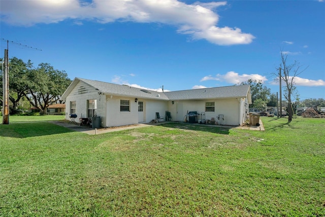 back of house with a yard and a patio