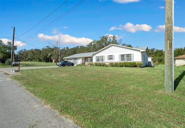 ranch-style home with a front lawn