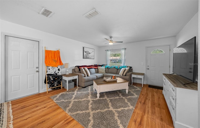 living room featuring ceiling fan and wood-type flooring