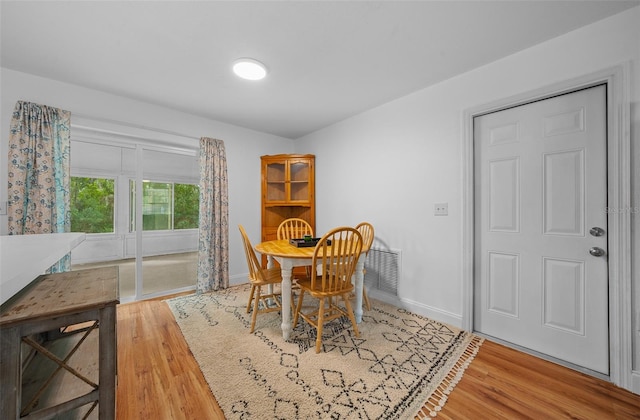 dining area with hardwood / wood-style floors