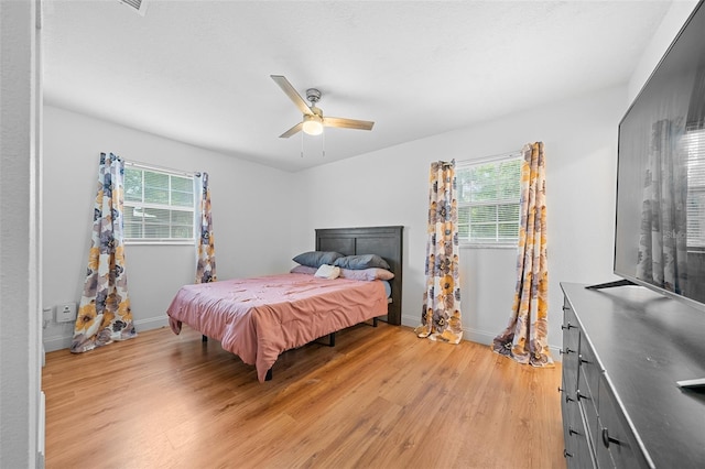 bedroom featuring light hardwood / wood-style floors and ceiling fan