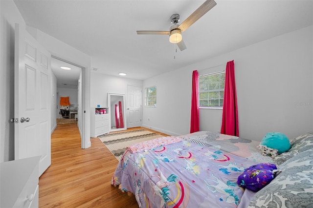 bedroom featuring light wood-type flooring and ceiling fan