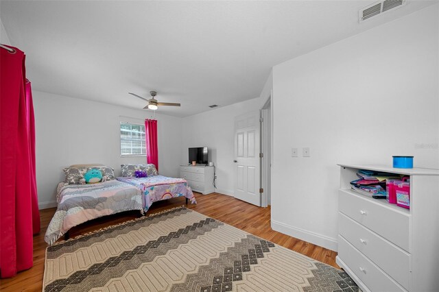 bedroom with light hardwood / wood-style flooring and ceiling fan