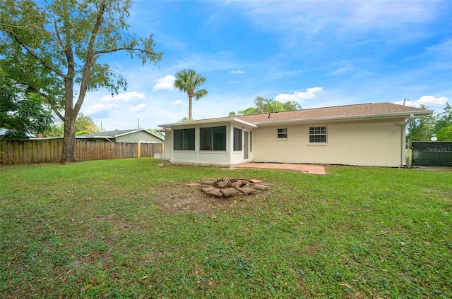 rear view of property with a yard