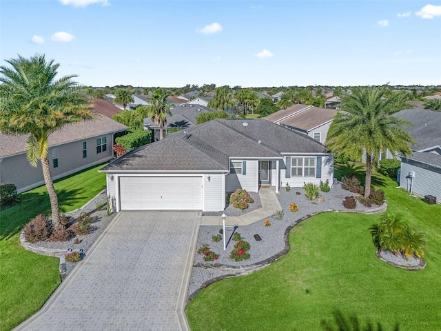 ranch-style home featuring driveway, a residential view, a front lawn, an attached garage, and a shingled roof