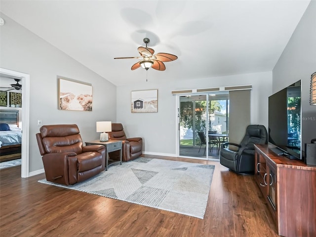 living room with ceiling fan, dark wood-type flooring, and vaulted ceiling