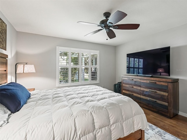 bedroom featuring hardwood / wood-style flooring, radiator heating unit, and ceiling fan