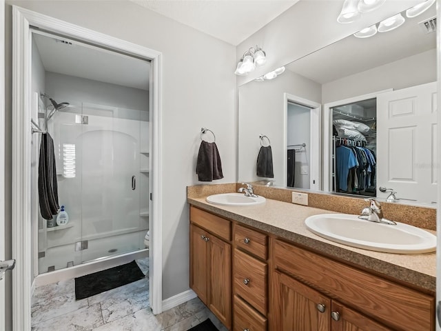 bathroom with a shower with door, vanity, and toilet