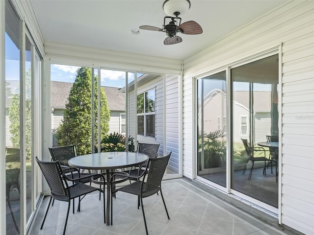 sunroom / solarium featuring ceiling fan