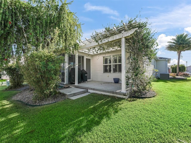 rear view of property featuring a pergola, a patio, central AC, and a lawn