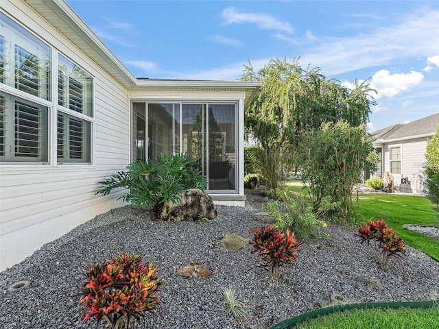 view of exterior entry with a lawn