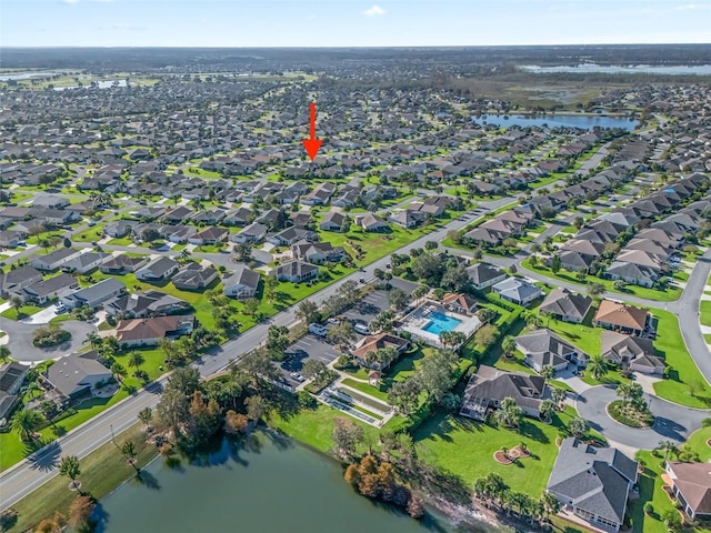 drone / aerial view with a water view and a residential view