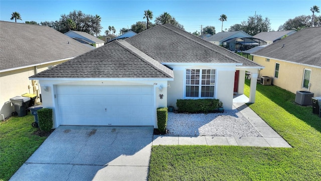 view of front of property with a garage, a front lawn, and central air condition unit