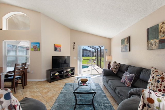 tiled living room with a textured ceiling and vaulted ceiling