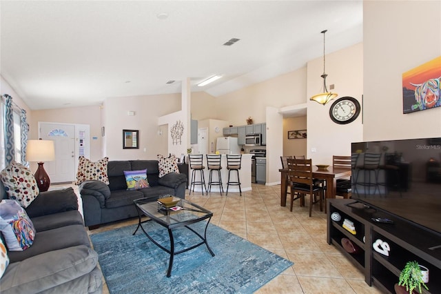 living room featuring light tile patterned flooring and vaulted ceiling