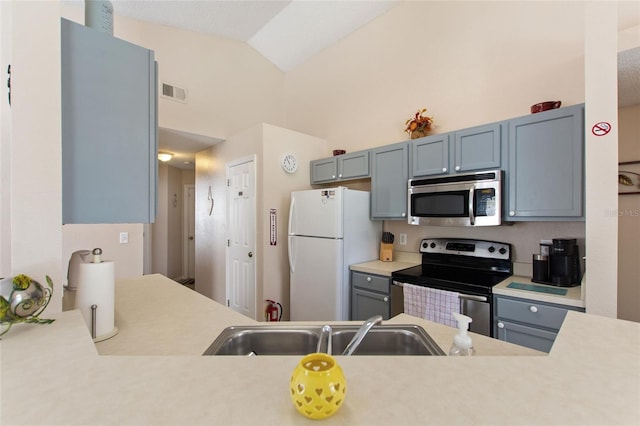 kitchen featuring high vaulted ceiling, stainless steel appliances, and sink