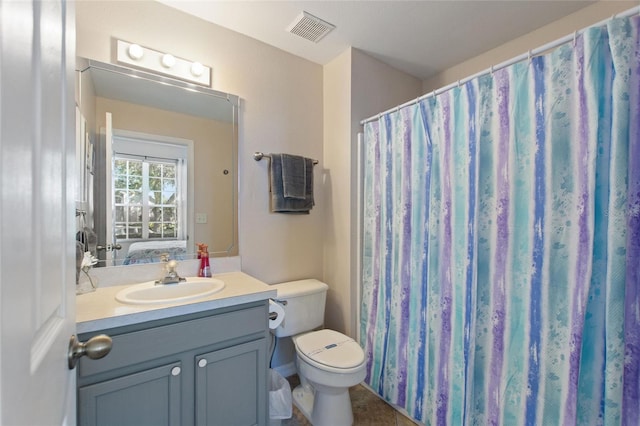 bathroom with vanity, toilet, and tile patterned floors