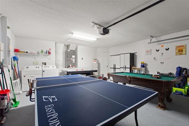 recreation room featuring pool table, a textured ceiling, heating unit, and washing machine and dryer