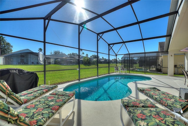 view of swimming pool with a yard, a patio area, glass enclosure, and a grill