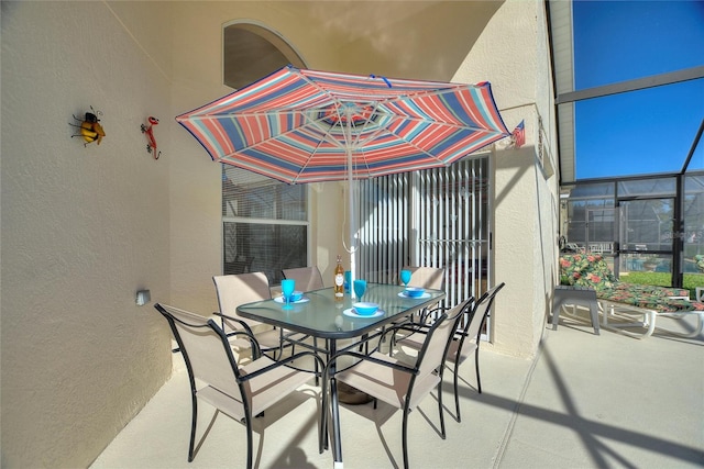 view of patio / terrace featuring glass enclosure