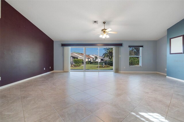 unfurnished room featuring light tile patterned floors, vaulted ceiling, and ceiling fan