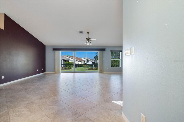 tiled spare room featuring lofted ceiling and ceiling fan