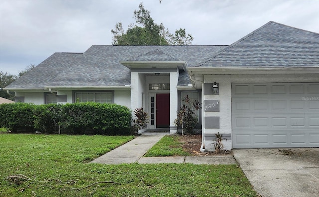 ranch-style home featuring a garage and a front yard