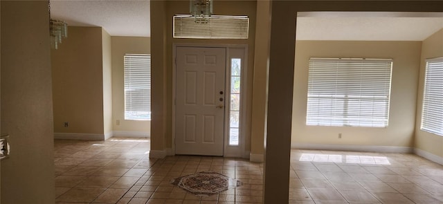 tiled foyer entrance with a textured ceiling