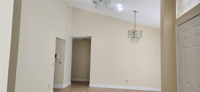 interior space featuring a notable chandelier, light tile patterned floors, and lofted ceiling