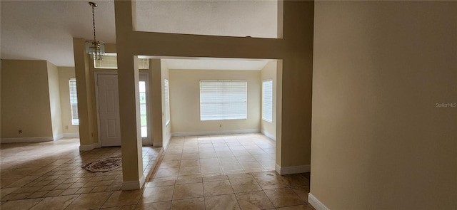 tiled entrance foyer featuring a towering ceiling