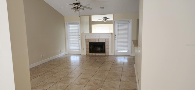 unfurnished living room featuring ceiling fan, a tile fireplace, and light tile patterned flooring