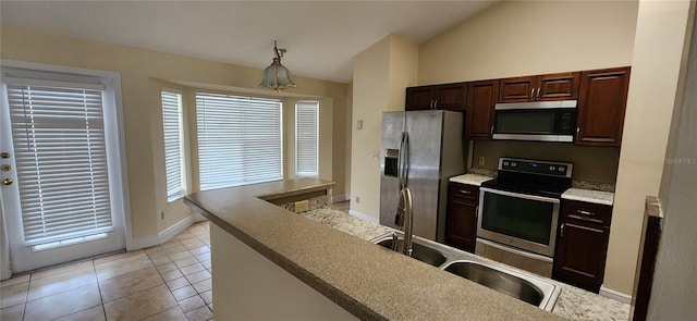 kitchen featuring dark brown cabinets, vaulted ceiling, sink, light tile patterned floors, and stainless steel appliances