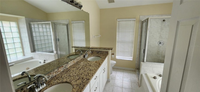 full bathroom with a wealth of natural light, vanity, lofted ceiling, and tile patterned flooring