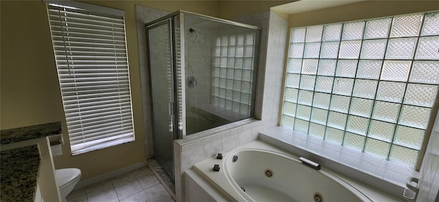 bathroom with separate shower and tub, toilet, tile patterned floors, and a wealth of natural light