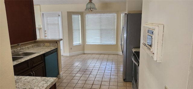 kitchen with dark brown cabinets, dishwasher, sink, light tile patterned floors, and stainless steel refrigerator