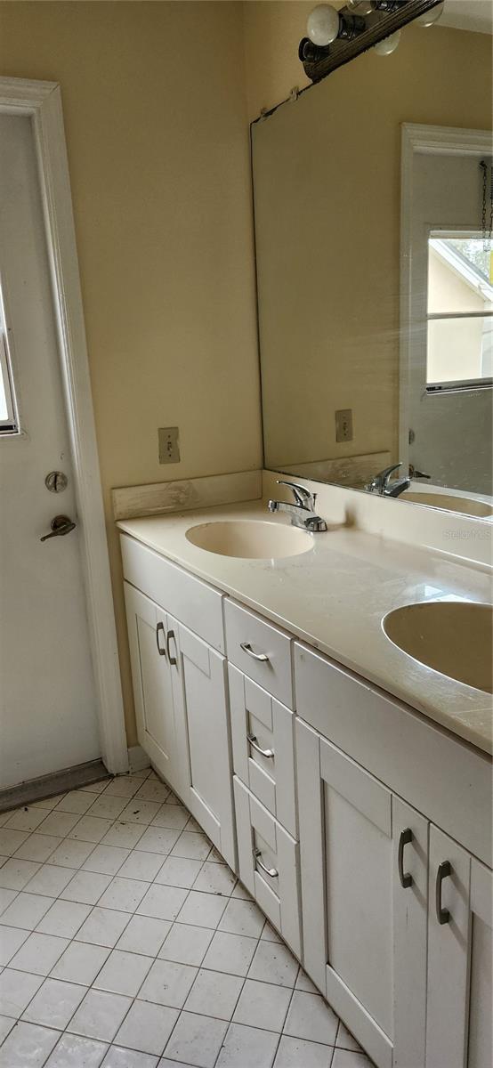 bathroom featuring tile patterned flooring and vanity